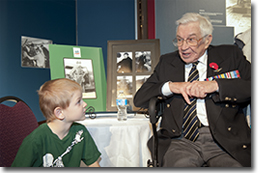 Second World War veteran Jerry Bowen speaking to a visitor, Remembrance Day 2012.
© Canadian War Museum, photo Mark Holleron, CWM2012-0064-0075-Dm
