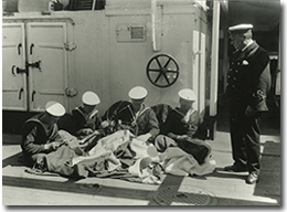 Canadian sailors from the HMCS Niobe sewing flags, no date.
George Metcalf Archival Collection
CWM 20030174-085
© Canadian War Museum
