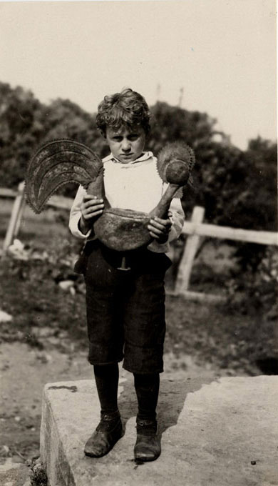 One of the young sons of Auguste Lemelin holding a weather vane in the shape of a rooster, made of tin., © CMC/MCC, 65769