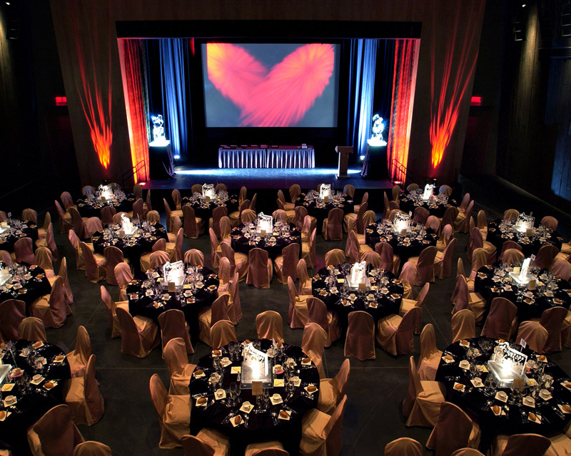 The Barney Danson Theatre at the Canadian War Museum in Ottawa, with tables and chairs set up for an event.