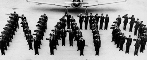 A group of people standing in front of a plane at the Canadian War Museum in Ottawa.