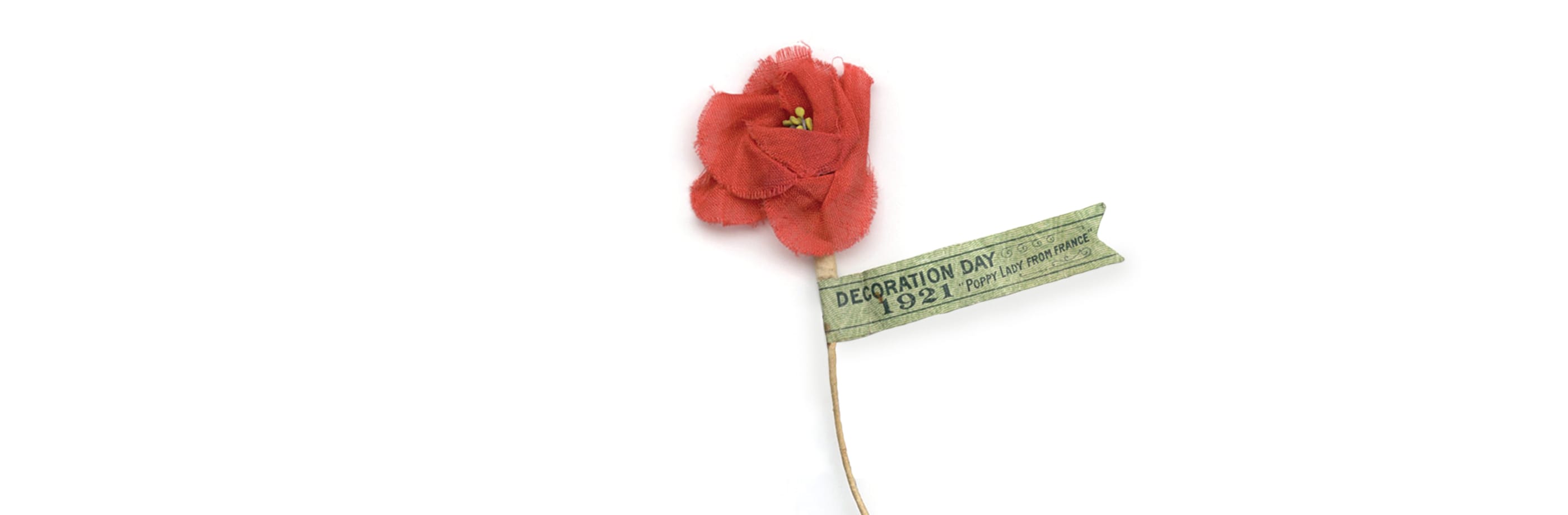 A red flower on a stick with a tag on it displayed at the Canadian War Museum in Ottawa.