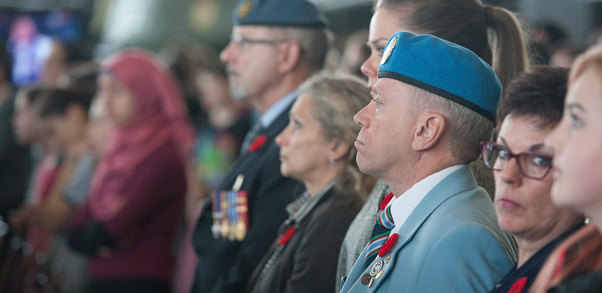 A group of people in military uniforms watching a ceremony at the Canadian War Museum in Ottawa.