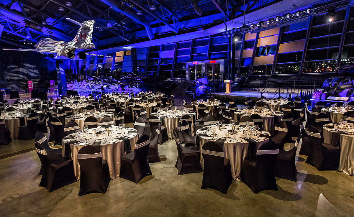 A large room with tables and chairs set up for a dinner in the Lebreton Gallery.