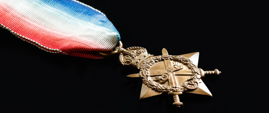 A medal with a red, white and blue ribbon displayed at the Canadian War Museum in Ottawa.