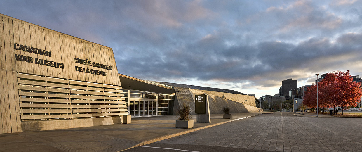 The Canadian War Museum in Ottawa is a building with a concrete exterior and trees in the background.