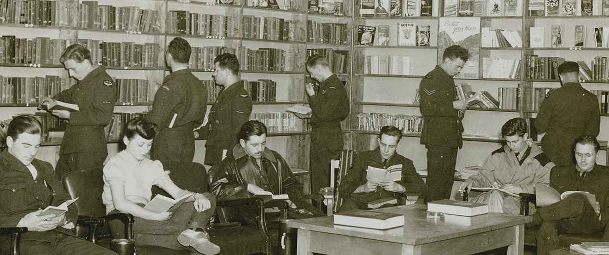 A group of people reading books in a library in Ottawa.