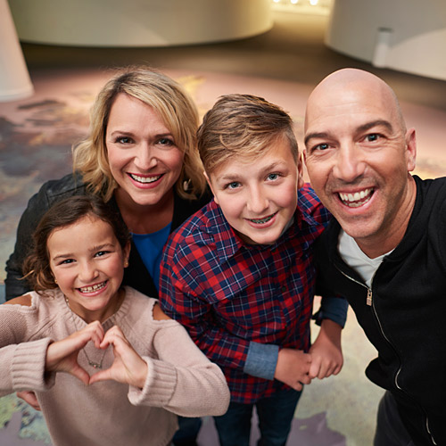 A family is taking a selfie at the Canadian War Museum in Ottawa.