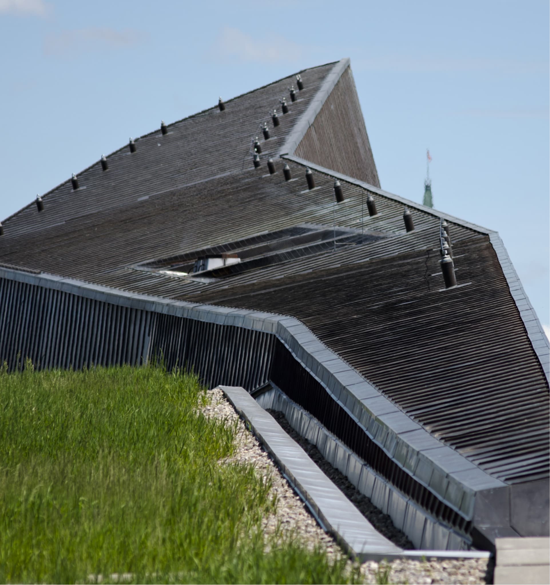 The Canadian War Museum in Ottawa, featuring a unique building with a roof made of metal and grass.