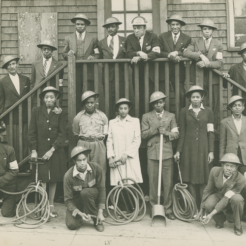 A group of people posing wearing helmets.