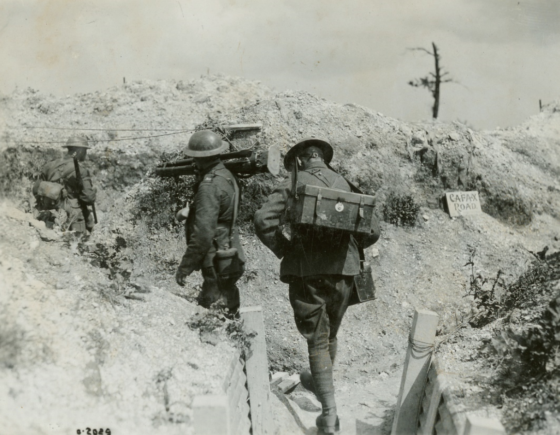 A group of soldiers walking down a dirt path.