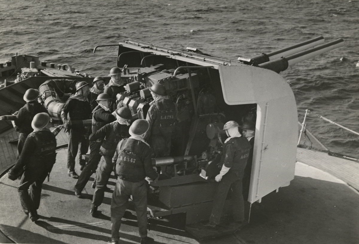 A group of men on the deck of a ship at the Canadian War Museum.