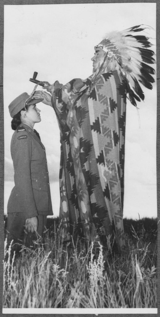 An old black and white photo of a man in a native headdress displayed at the Canadian War Museum in Ottawa.