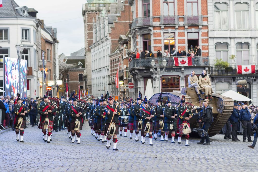 A group of Canadian soldiers marching down a cobblestone street in Ottawa.