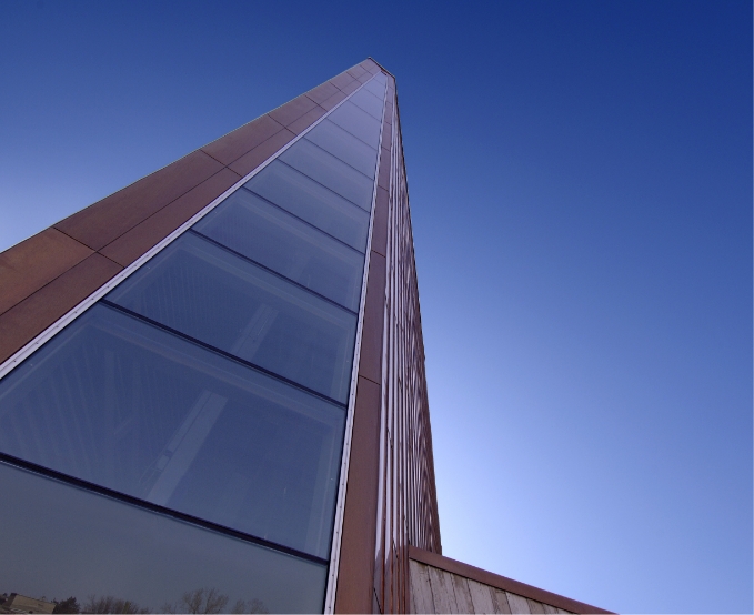 The Canadian War Museum, located in Ottawa, appearing as a tall building with a blue sky backdrop.