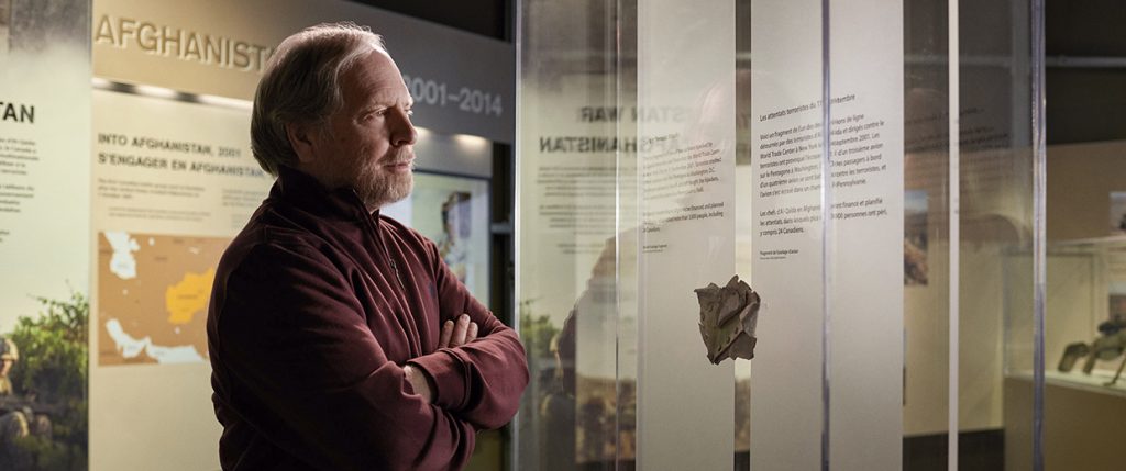 A man standing in front of a display of information.