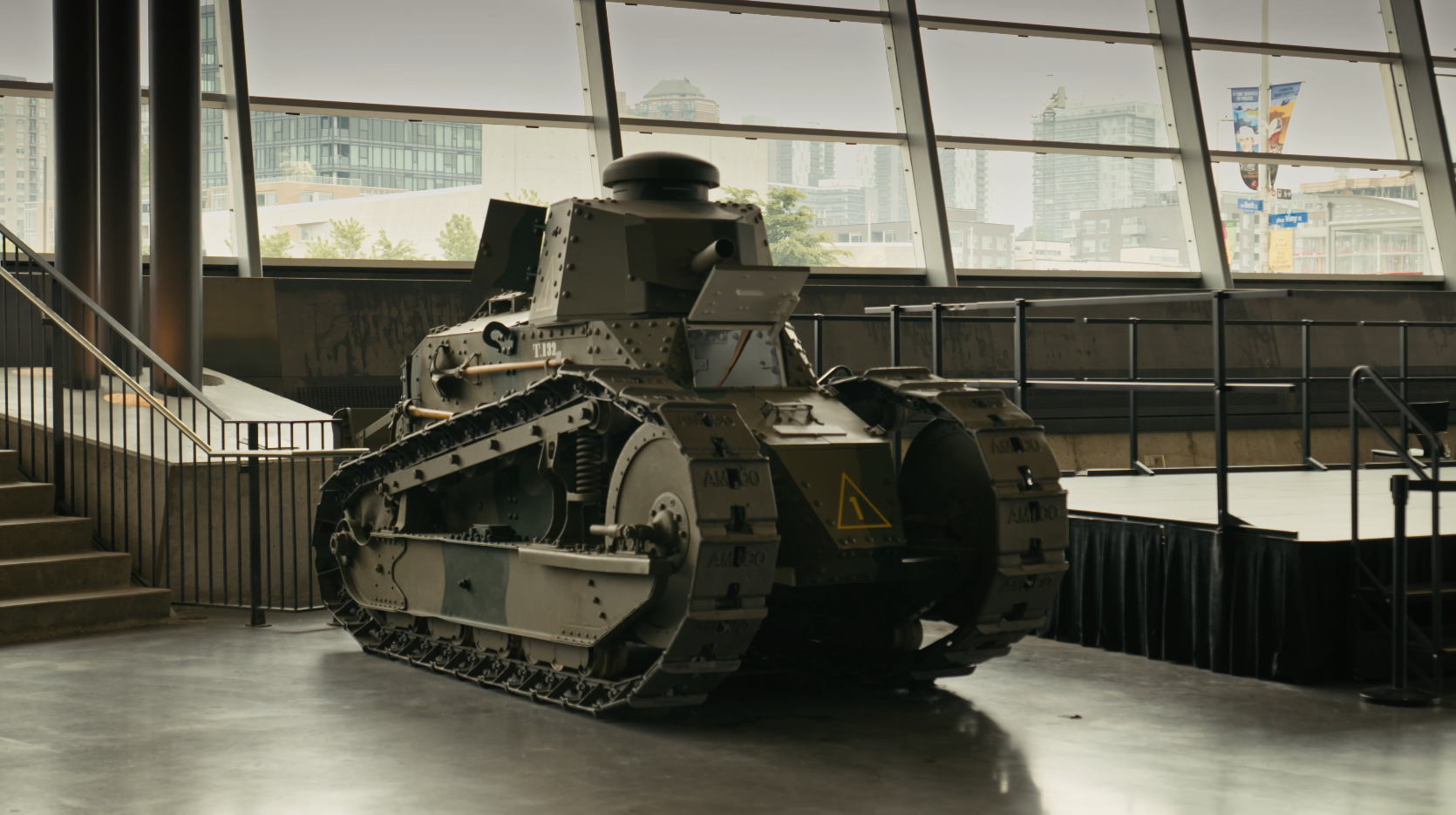 War tank parked beside a stage.