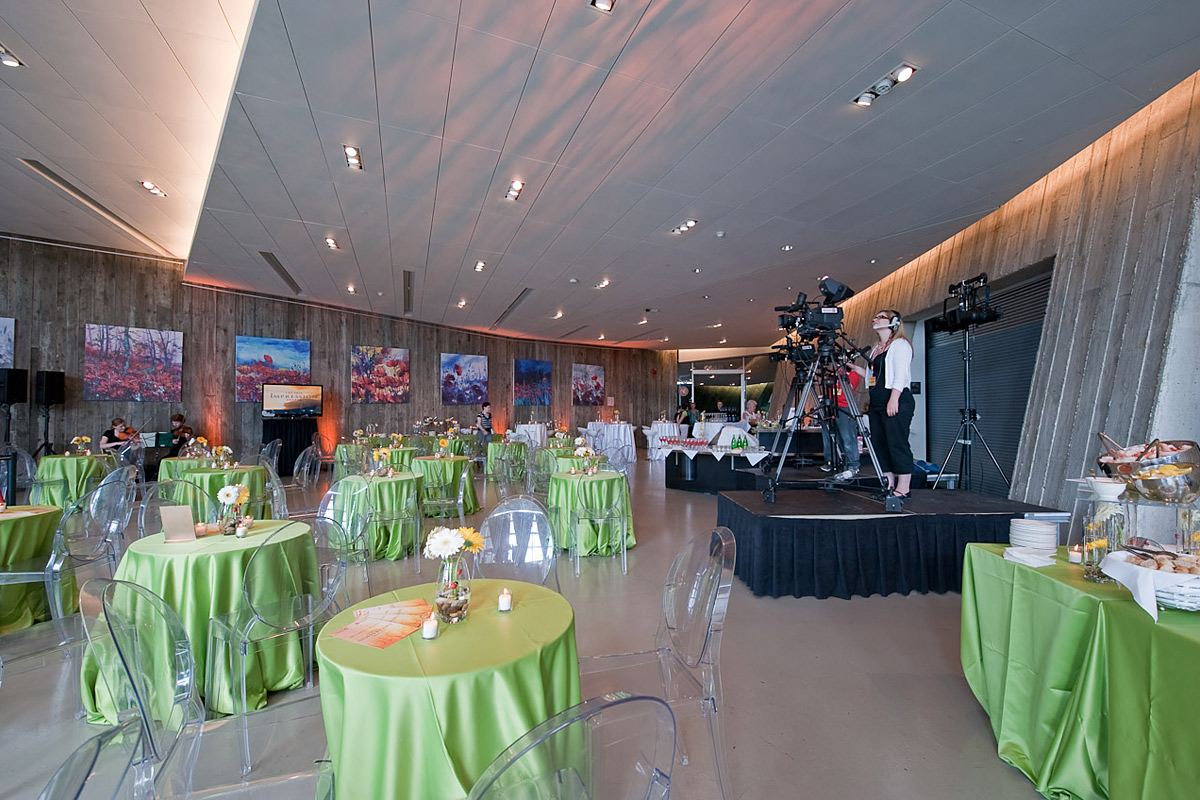 Tables set banquet-style surrounding a stage at the Canadian War Museum.